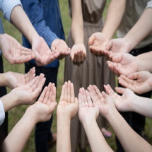 Group of Asian people raise up their right hands and handle gently to obtain and sharing good feeling to gether in Training Teambuilding.